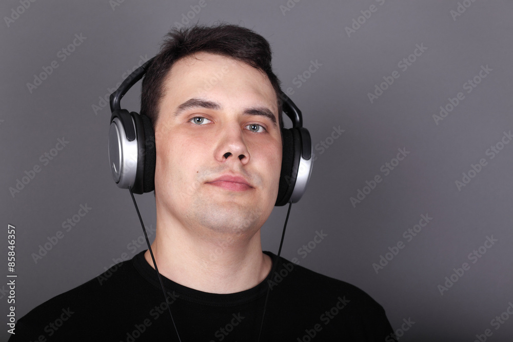 Beautiful young man in headphones and black t-shirt Beautiful young man in headphones and black t-shirt