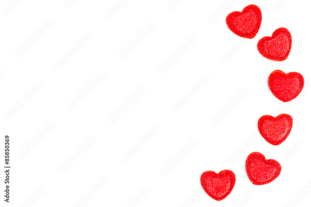 Red heart-shaped sugar sprinkles on white background Red heart-shaped sugar sprinkles on white background