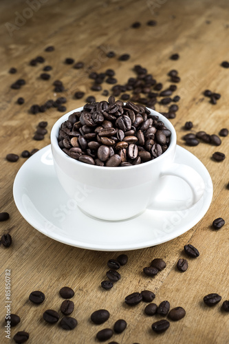 Cup full of coffee beans on the table