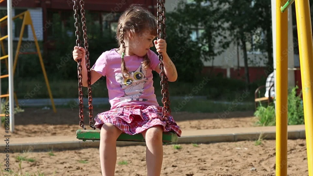 Little girl in pink swings at playground at sunny day
Little girl in pink swings at playground at sunny day