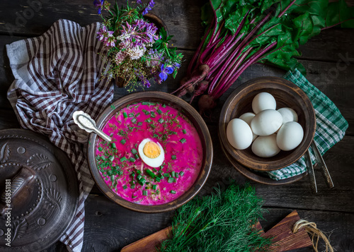  Russian cold soup with beetroot, bowl,spoons,greenery on dark wooden table. Style rustic. photo