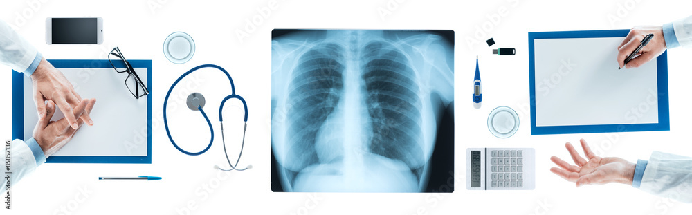 Medical team discussing during a briefing, x-ray image at center, top view, unrecognizable people Medical team discussing during a briefing, x-ray image at center, top view, unrecognizable people