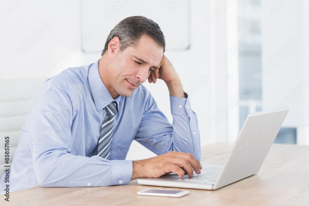 Frustrated businessman working with his computer Frustrated businessman working with his computer