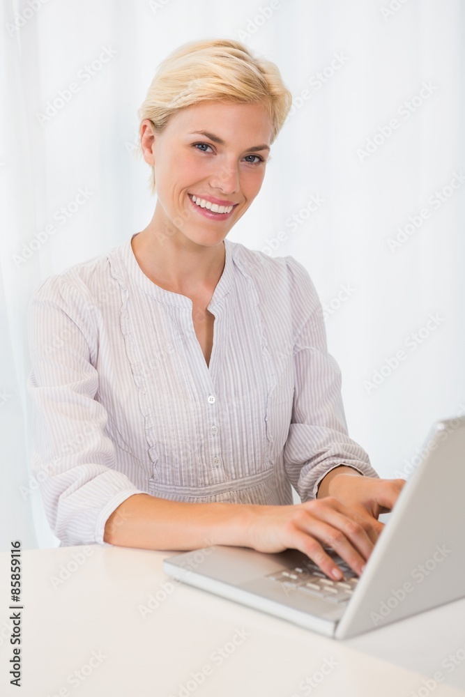 Portrait smiling blonde woman using laptop Portrait smiling blonde woman using laptop