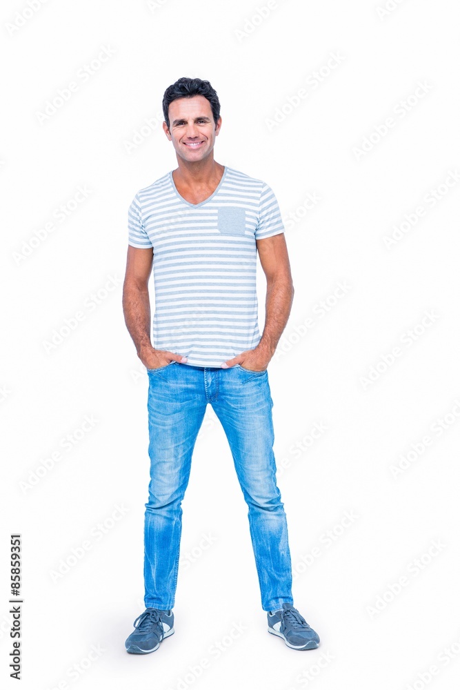 Happy man smiling at camera with hands in pocket