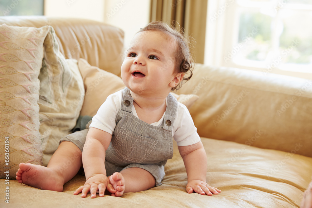 Happy Baby Boy Playing On Sofa At Home Happy Baby Boy Playing On Sofa At Home