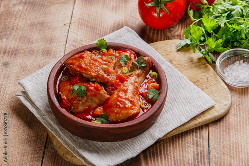 chicken in tomato sauce in a bowl chakhokhbili