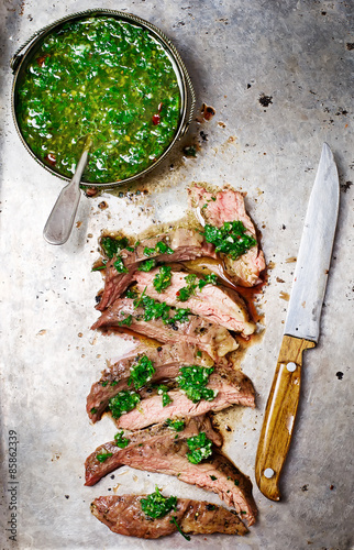 Fotografie flank steak  with chimichurri sauce.