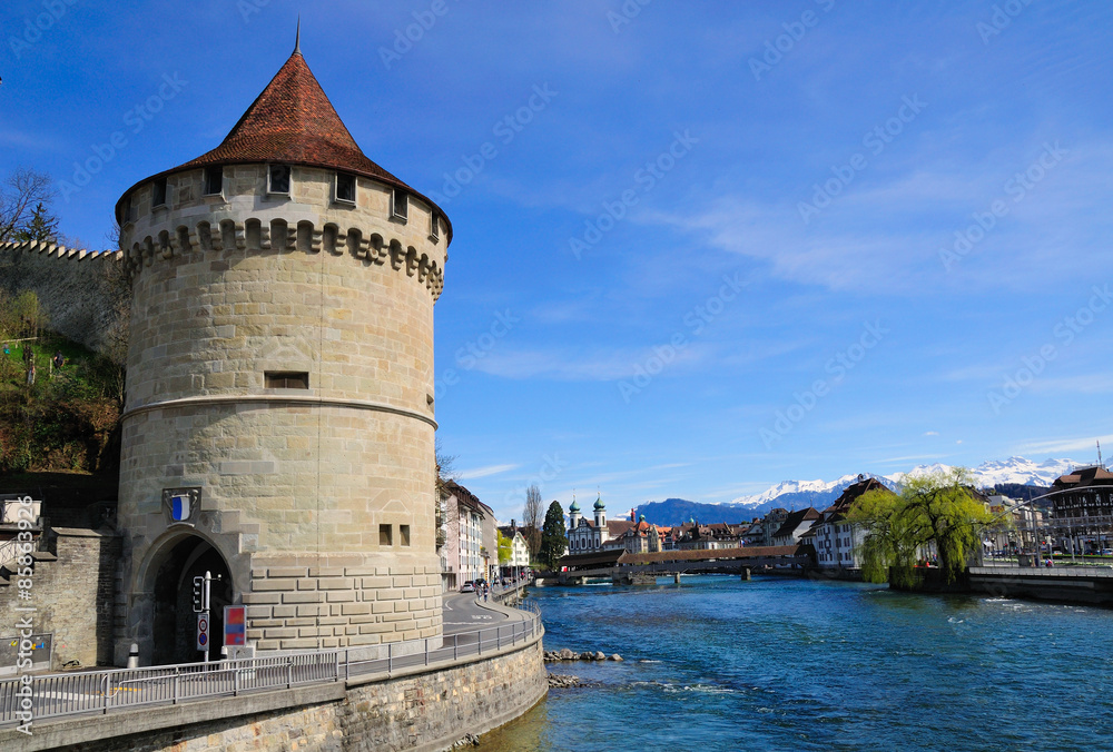 View to reuss river embankment with round tower. Lucern. Switzerland.  