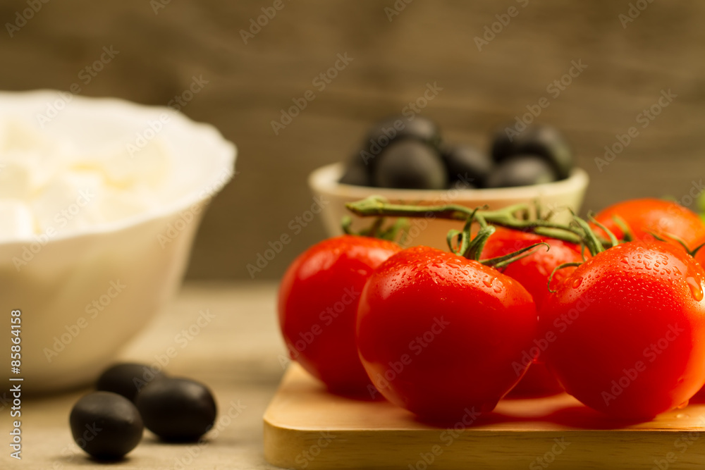 Home cooking summer Greek salad on wooden background Home cooking summer Greek salad on wooden background