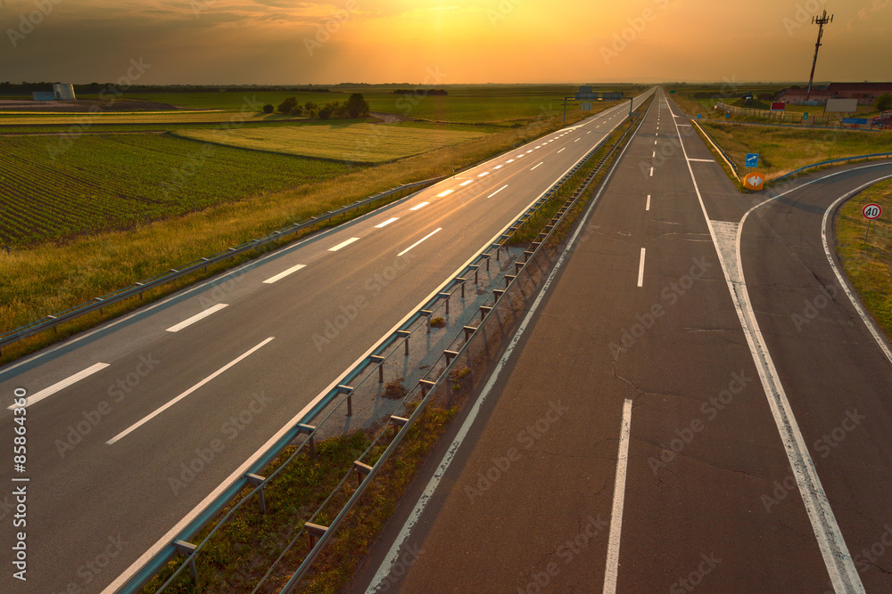Driving on an empty motorway at sunset Driving on an empty motorway at sunset