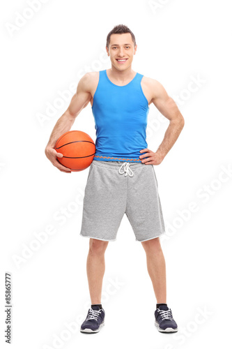 Young male athlete holding a basketball
