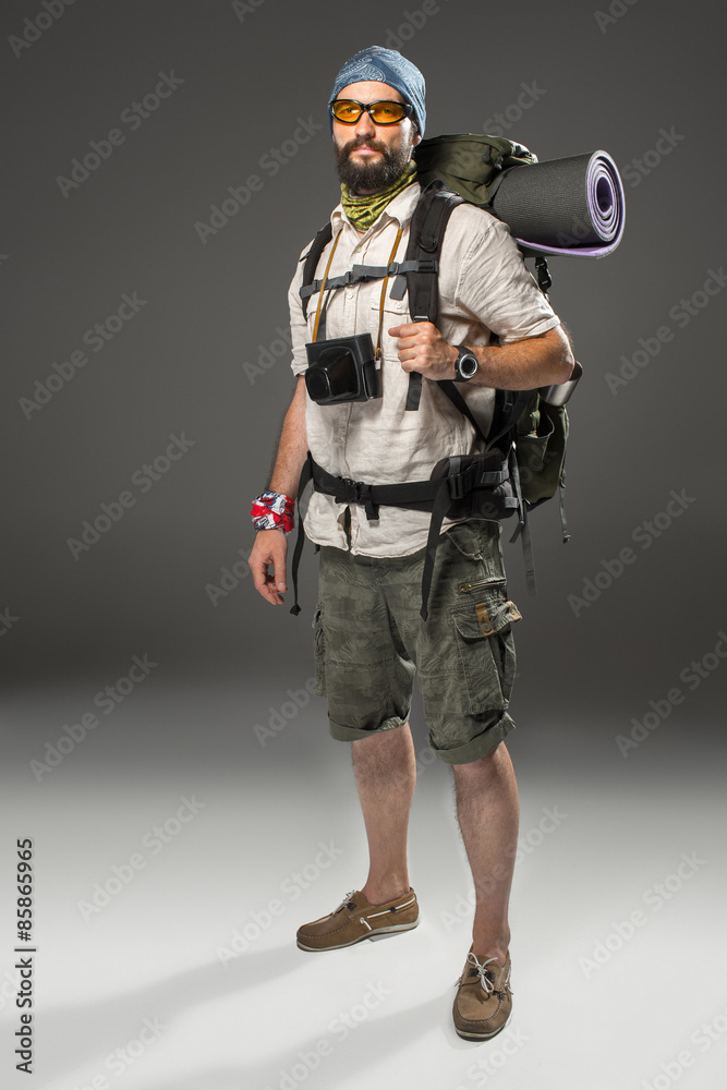 Full length portrait of a male fully equipped tourist 