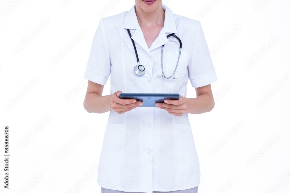 Standing doctor using tablet Standing doctor using tablet
