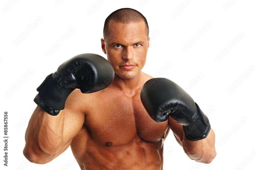 Muscular man in with boxer gloves on white background