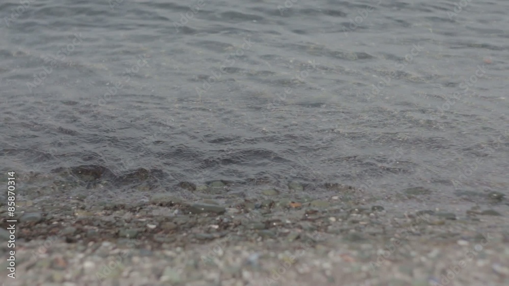 Small Sea Waves; Small calm sea waves going into some little rocks. Low DOF. Small Sea Waves; Small calm sea waves going into some little rocks. Low DOF.