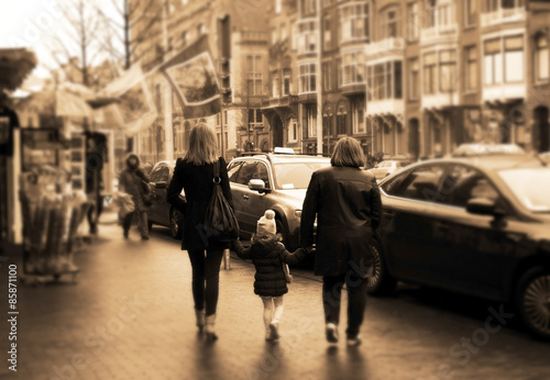 two women walking with a child