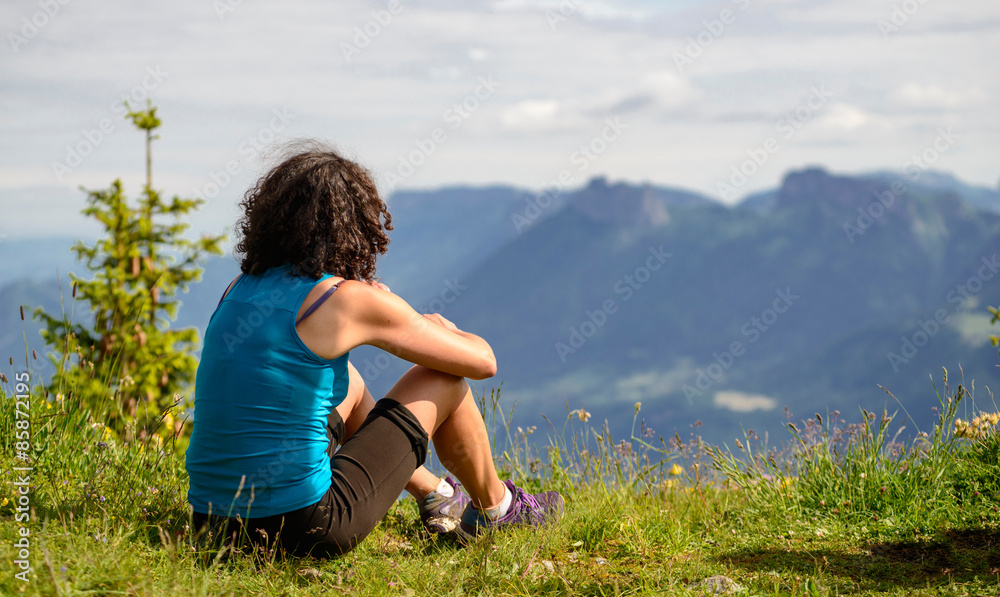 woman sitting on cliff and looking at landscape woman sitting on cliff and looking at landscape