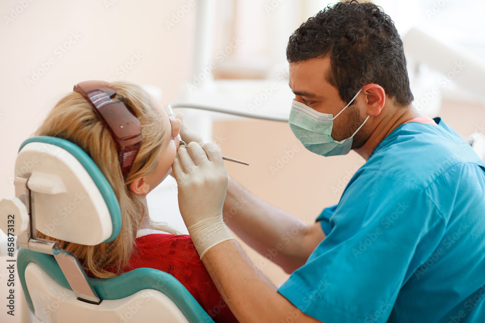 Fototapeta premium Dentist and female pacient at dental clinic tooth care