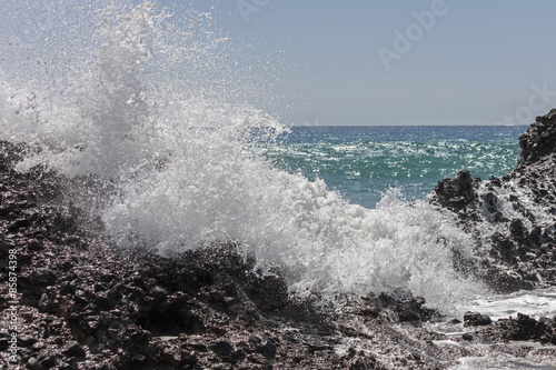A big wave breaks against the rocks on falasarna beach, Crete.