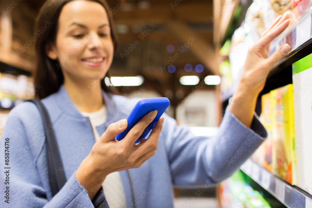 happy young woman with smartphone in market happy young woman with smartphone in market