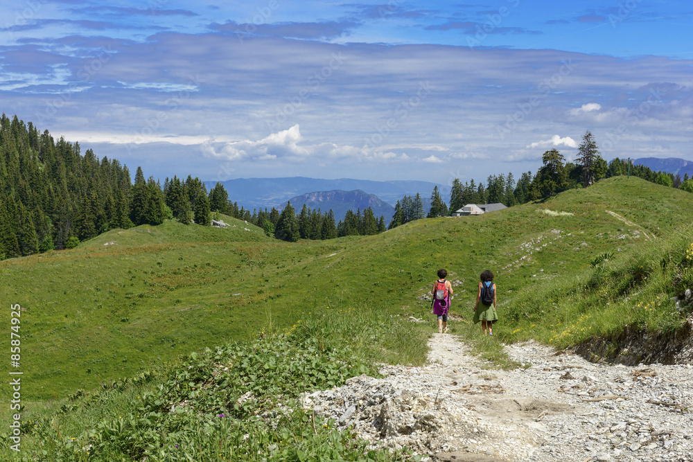 Two hikers walking in the mountains