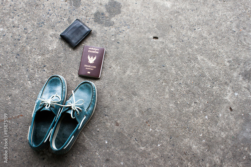 Shoes on the cement floor. and passport ready to go travel.wallet