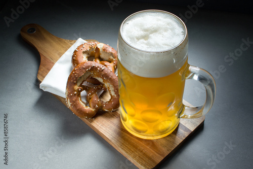 Canvas Print 2 Brezn/Pretzels on a breadboard with beer 2