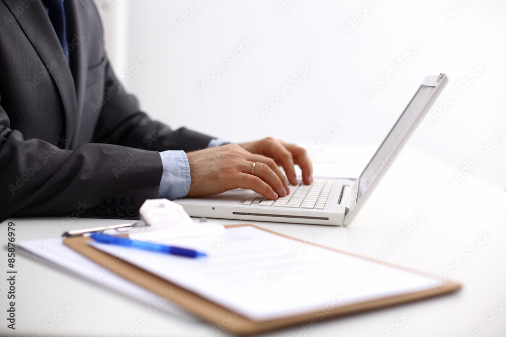 working on laptop, close up of hands of business man working on laptop, close up of hands of business man