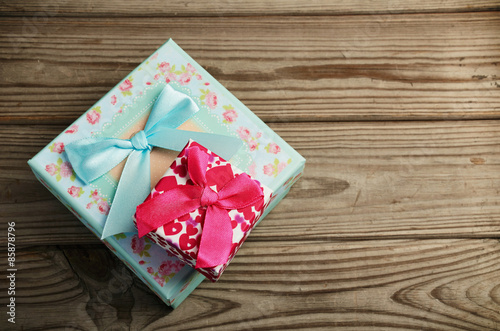 Two gift boxes on a wooden background. horizontal