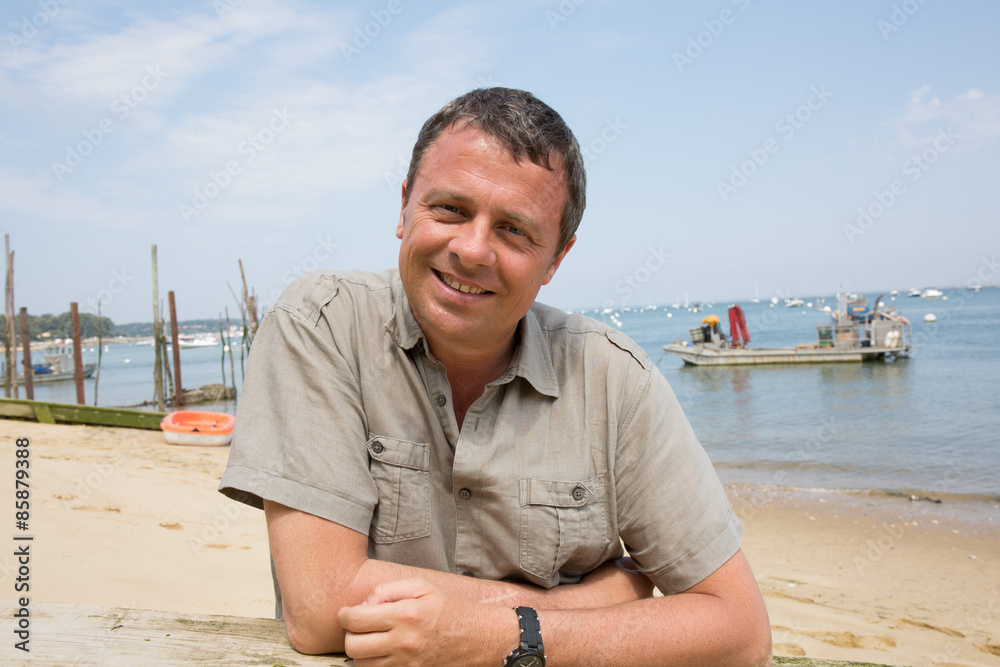 Charming man at the beach on holidays