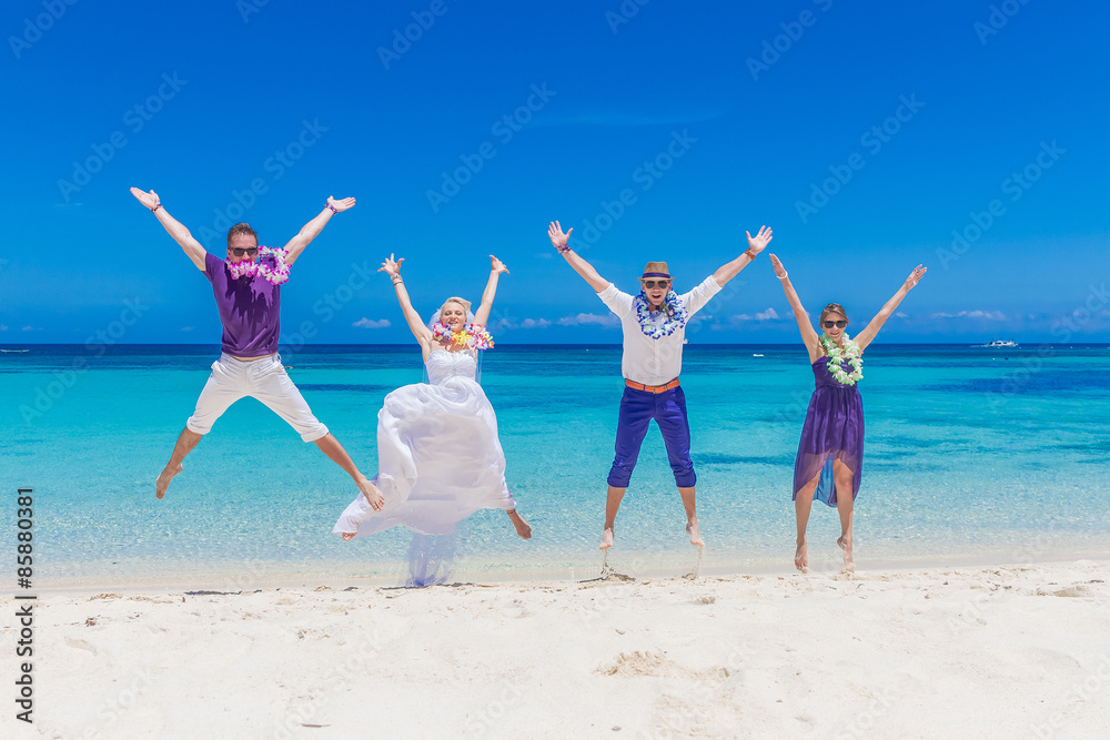 bride, groom and guests enjoying beach wedding in tropics, on we bride, groom and guests enjoying beach wedding in tropics, on we