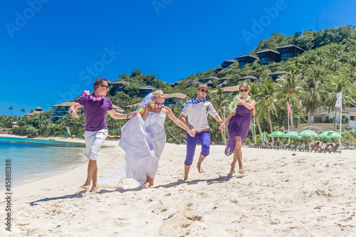 bride  groom and guests enjoying beach wedding in tropics  on we