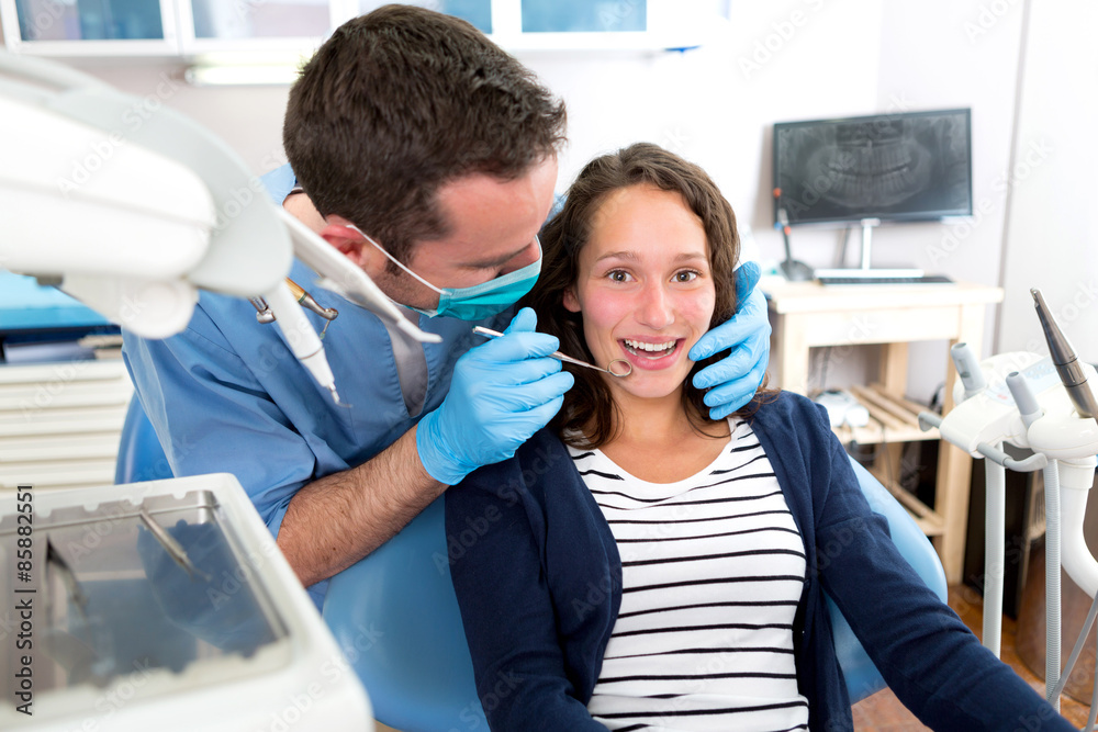 Young attractive woman being cured by a dentist Young attractive woman being cured by a dentist