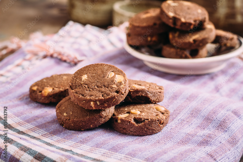 Fototapeta premium Chocolate and hazelnuts cookies on cloth