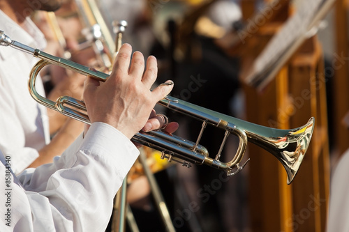 The pipe is in the hands of a musician in the orchestra