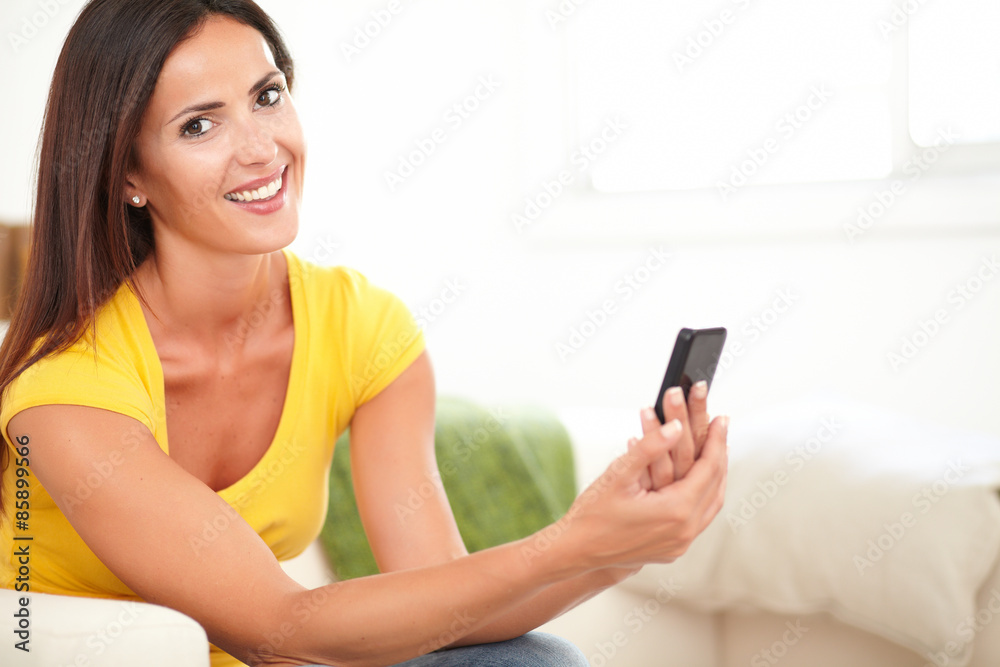 Attractive woman holding a mobile phone Attractive woman holding a mobile phone