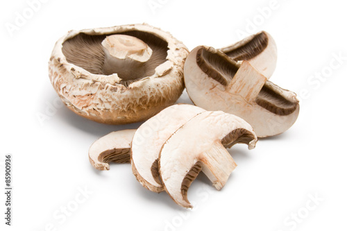 Portobello Mushrooms – Portobello mushrooms, whole and sliced. On a white background.