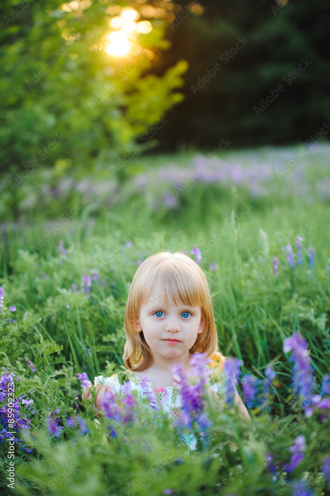Cute cheerful blond girl playing in the park Cute cheerful blond girl playing in the park