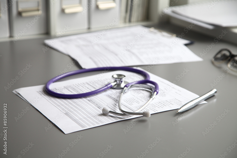 Stethoscope on the grey desk, close up Stethoscope on the grey desk, close up