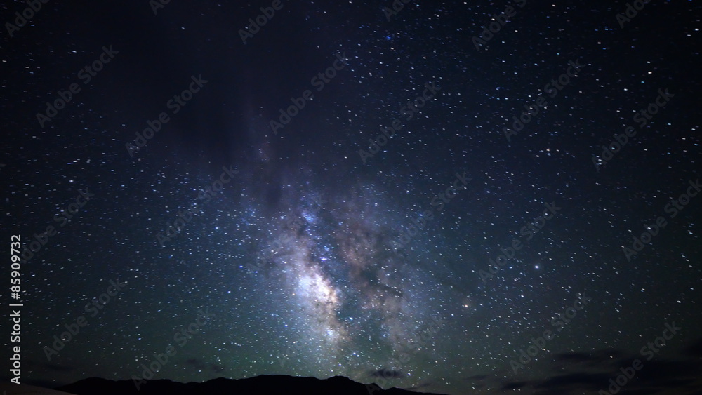  Astrophotography time lapse footage with zoom out motion of Milky Way galaxy over desert sand dunes in Death Valley National Park, California