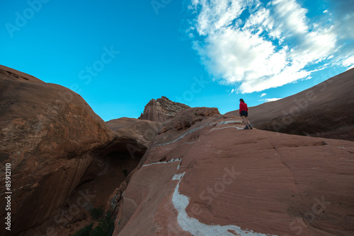 Woman walking on a slickrock Cave Point Escalante Utah photo