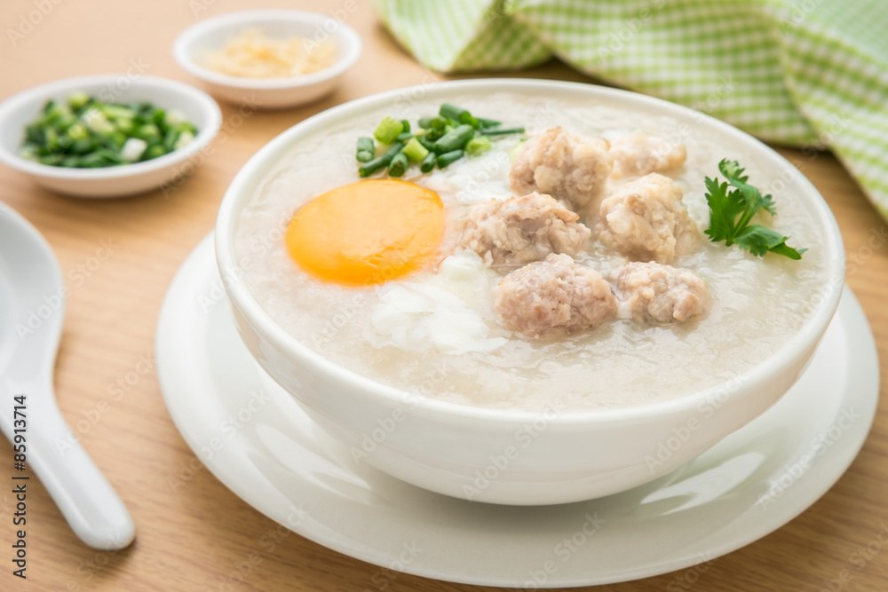 Congee with minced pork and boiled egg in bowl Congee with minced pork and boiled egg in bowl