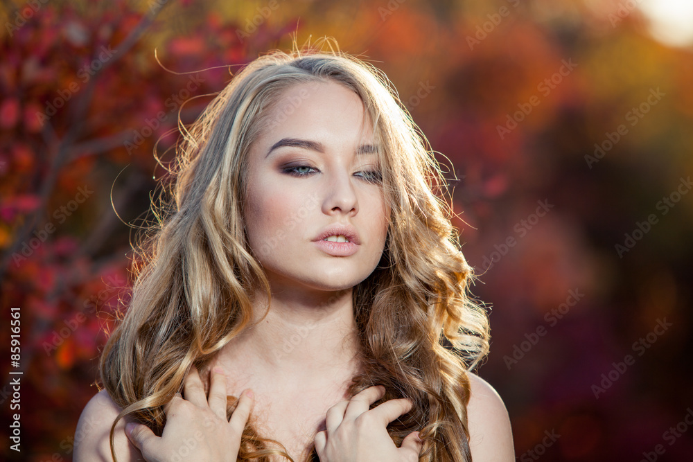 beautiful young woman with curly hair against a background of beautiful young woman with curly hair against a background of