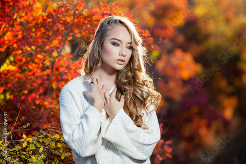 beautiful young woman with curly hair against a background of