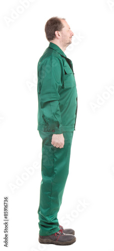 Worker in green overalls. 