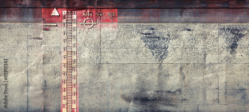 Gray grungy barge hull texture with scale photo
