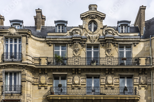 Traditional French house: balconies and windows. Paris, France.