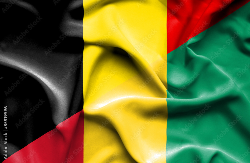 Obraz premium Waving flag of Guinea and Belgium