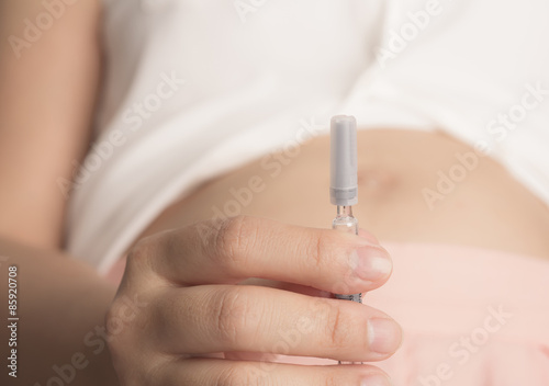 Pregnant woman with syringe in hand   Filtered image processed v